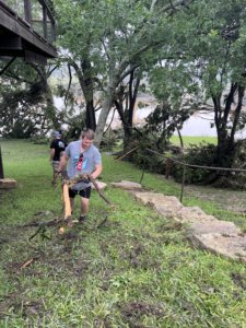 Cleaning up debris following flooding at Tree Top Cabins.