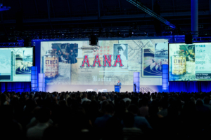 Audience watches Jeff Molter at the 2026 AANA Annual Congress beneath a large display of anesthesia history and AANA imagery.